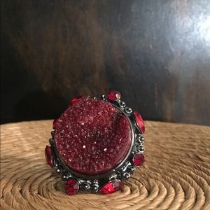 Large Red Stone Ring with surrounding stones.
